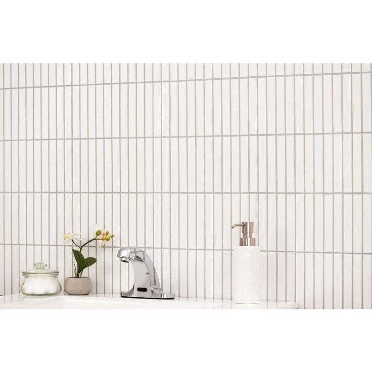 a bathroom sink with a faucet, soap dispenser and toothbrush holder