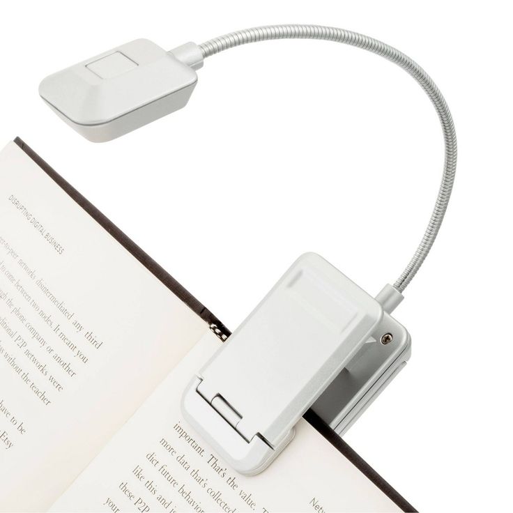 an open book with a light attached to it and a cord connected to the cover