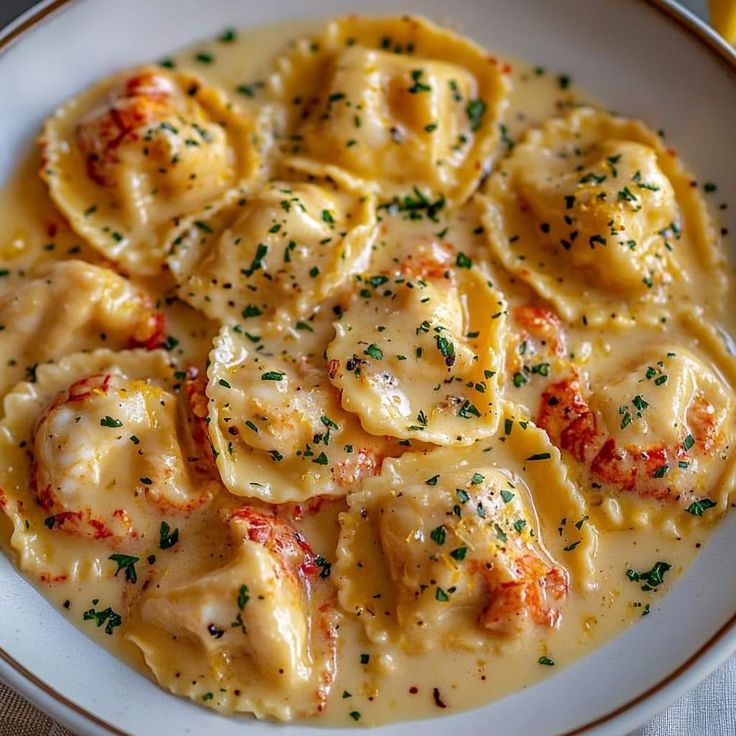 a white plate topped with ravioli and cheese