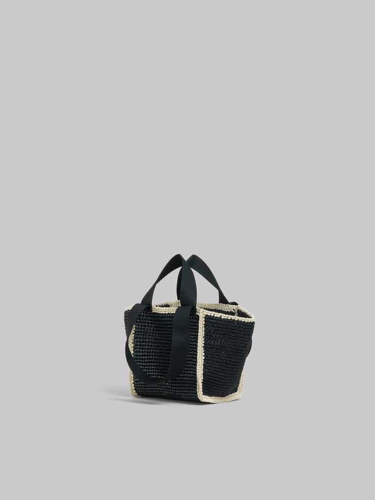 Small macramé Sillo shopper woven from raffia-effect yarn. Gusset construction with double tape handles. Hand-stitched Marni mending logo on the front with flower detail. Evening Woven Tote Bucket Bag, Evening Rectangular Woven Bucket Bag, Woven Straw Tote Bag For Evening, Evening Woven Straw Tote Bag, Black Straw Bag With Rolled Handles, Luxury Woven Crochet Bag With Double Handle, Luxury Crochet Double Handle Bag, Modern Black Handwoven Bag, Black Straw Bag With Intrecciato Weave For Shopping