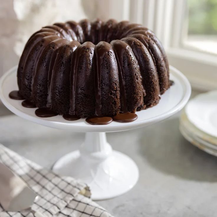 a bundt cake with chocolate icing and drizzled on the top