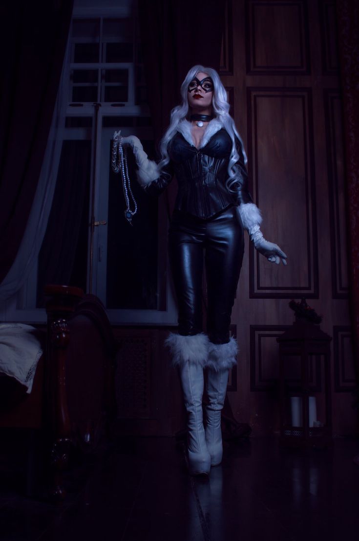 a woman dressed in black leather and white fur