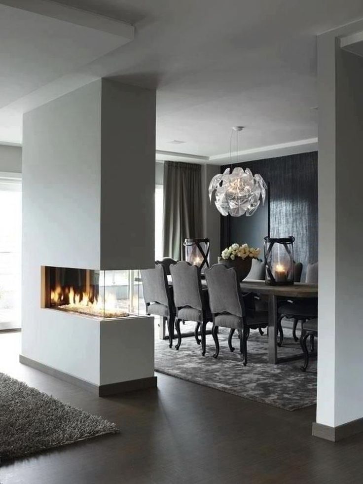 an elegant dining room with fireplace and chairs