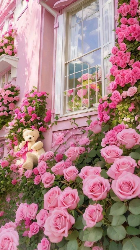 there is a teddy bear sitting on the window sill in front of pink roses