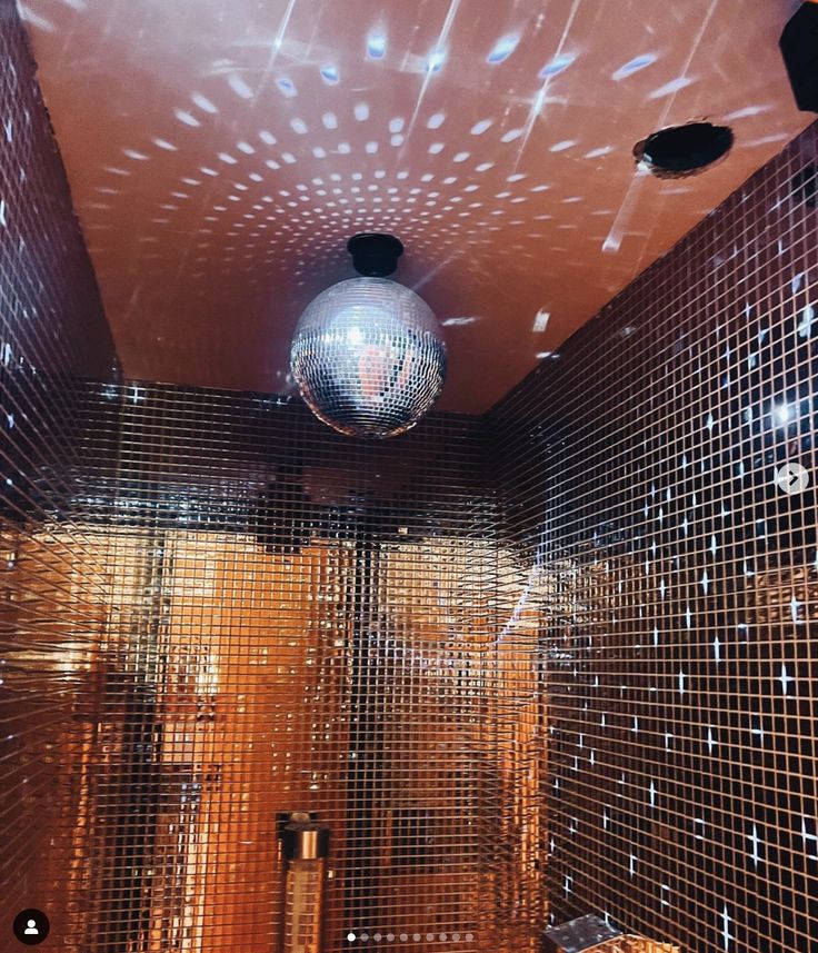 a disco ball hanging from the ceiling in a bathroom