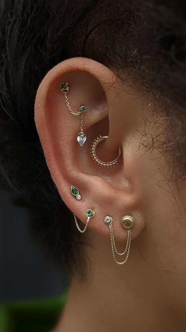 a woman wearing three different ear piercings