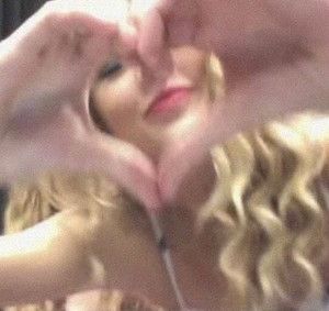 a woman making a heart with her hands