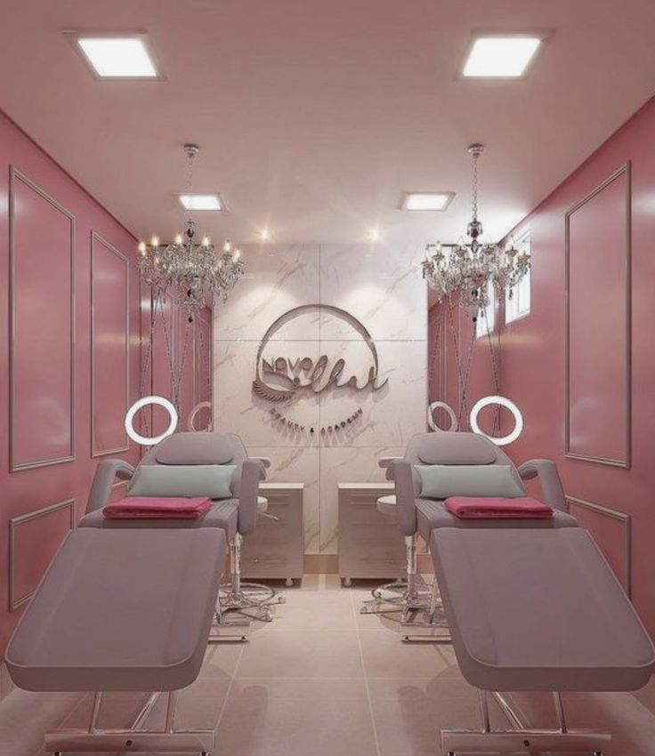 a salon with pink walls and chandeliers hanging from the ceiling