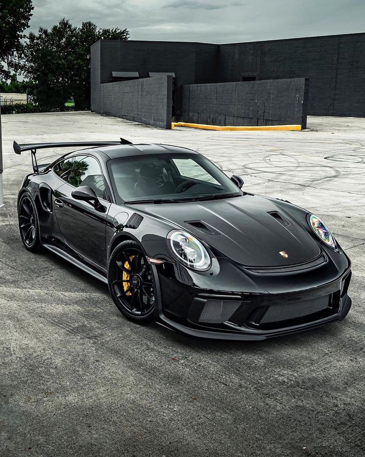 a black sports car parked in a parking lot