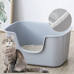 a gray cat sitting next to a litter box