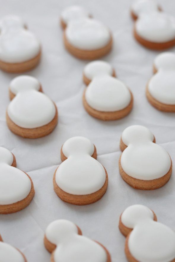 mickey mouse cookies with white icing on a table