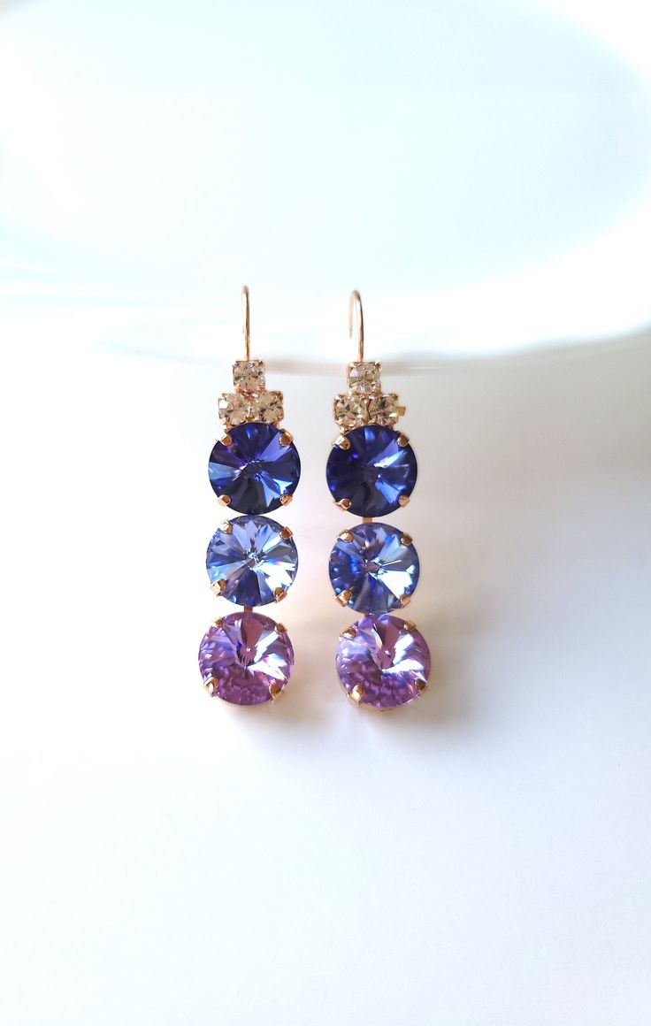 "The (3) crystal earrings are a show stopper.  I love the shades of purple in the earrings. I have handset the three 12mm round crystals in prong rose gold plated setting.  The earrings are also adorned with 3 small Clea Crystals.  The earwire is leverback. Earring length including earwire: 2  1/4\" Earring Weight:  Light- Medium The jewelry will arrive in a bow tied gift box.. To view more items available in my shop, please click the link below http://www.etsy.com/shop/Uniquebeadables Don't for Purple Chandelier, Tie Gift Box, Lilac Earrings, Shade Of Purple, Earrings Prom, Lavender Earrings, Prom Earrings, Earrings Rose Gold, Tie Gifts