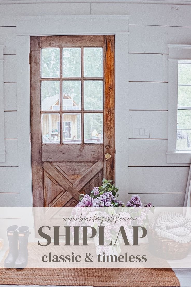 a door with the words shiplap on it and flowers in front of it