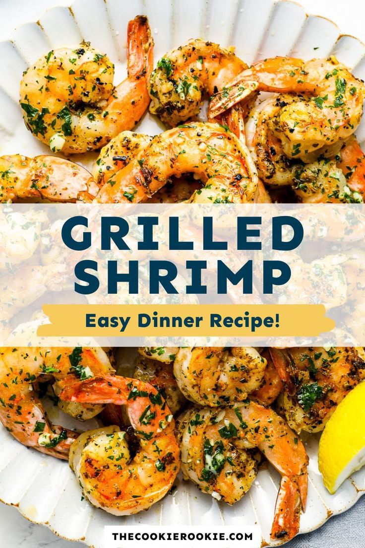 grilled shrimp on a white plate with lemon wedges and parsley garnish