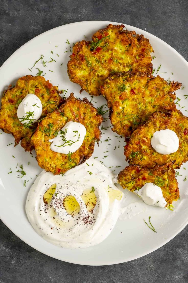 some food is on a white plate with sour cream