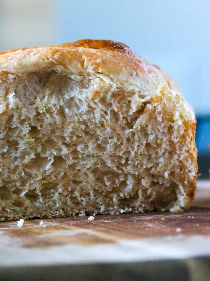 a loaf of bread sitting on top of a wooden cutting board