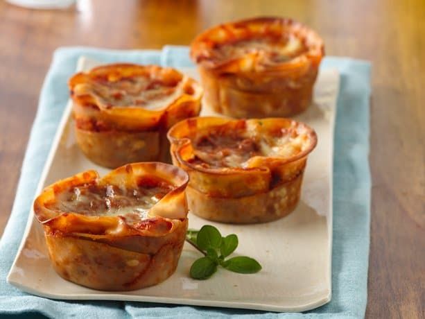 several mini quiche pies on a white plate