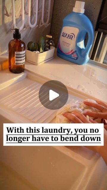 a person washing their hands in a sink with soap and other cleaning products on the counter