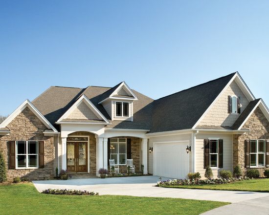 a large house with lots of windows and two garages