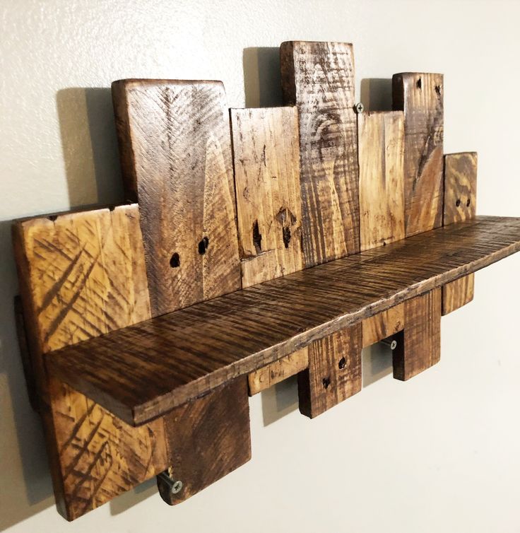 a wooden shelf sitting on top of a wall