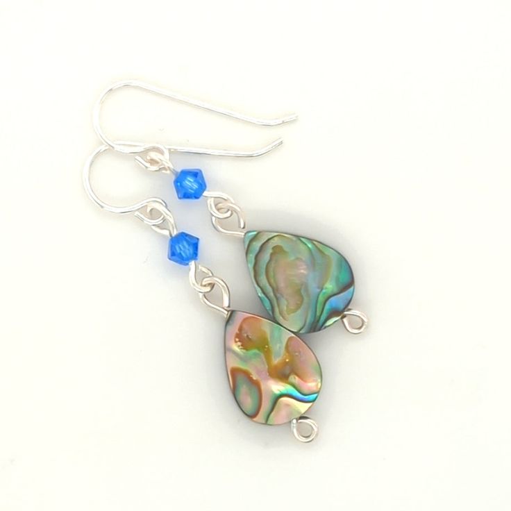 Elevate any look with my elegant Sterling Silver Abalone Dangle Earrings. Featuring a spinning abalone teardrop bead and a dark teal crystal accent, these ladies earrings are sure to impress. Choose from a large or small shell drop style to match your unique style. Abalone Shells - A sacred symbol of the sea. They help strengthen love within, foster interpersonal harmony, release negative feelings and ease stressful situations. Negative Feelings, Sacred Symbols, Stressful Situations, Teardrop Beads, Abalone Shell, Dark Teal, Spinning, Women's Earrings, Unique Style