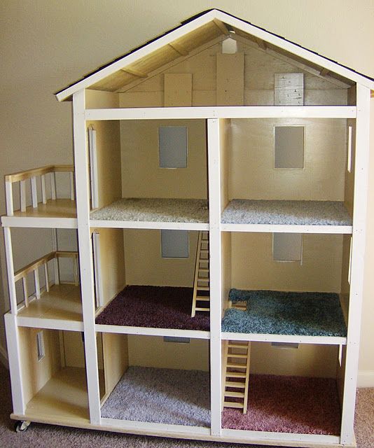 a doll house with multiple floors and stairs to the second floor is made out of cardboard