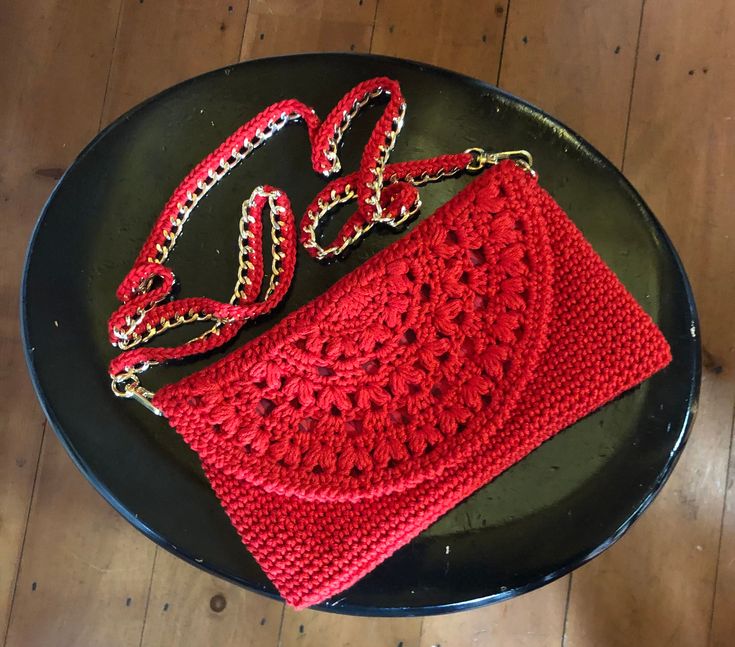 This Dehlia Clutch Crossbody Handbag has a boho vibe but can also be a dress up piece in your wardrobe! It's so versatile and adds a stunning look dressed up or down with any outfit. Perfect for wedding season or a trip to the outdoor market! The flap detail gives it a feminine touch and the gold chain strap is woven with the color of the bag.  The entire bag is machine lined and then hand stitched into the bag and flap. The linings are unique to each bag and will coordinate with the yarn color. It's made of mercerized cotton which gives it a rich sheen and sturdiness. The chain is approximately 42 inches for shoulder or crossbody, the bag itself measures 9 x 6 inches, perfect for just the essentials. Choose from over 25 colors too! As always, shipping is free! This is a DarlingDanaDesign Summer Party Shoulder Bag With Adjustable Strap, Chic Handmade Clutch, Chic Crochet Party Bag, Handmade Chic Clutch, Chic Shoulder Bag With Adjustable Strap For Festival, Bohemian Summer Evening Clutch, Handmade Bohemian Crochet Bag For Day Out, Chic Festival Bag With Adjustable Strap, Spring Chic Crochet Clutch Bag