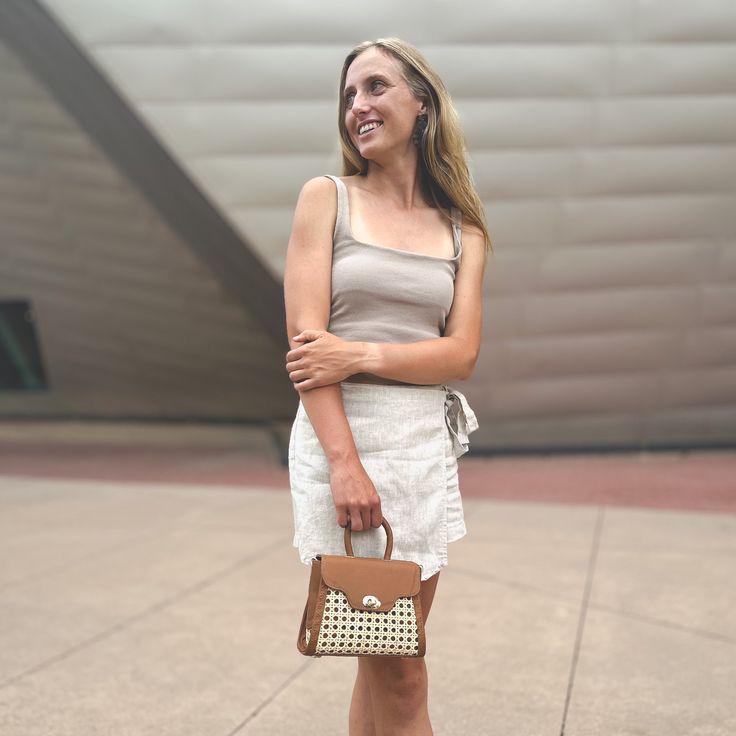 Our Mini Rattan Purse packs a punch when it comes to summertime style. It’s small enough to take anywhere, but the unique shape and contrasting textures make it the ultimate finishing touch. This bag is poised to be your newest wardrobe staple and, with a detachable crossbody strap, how you wear it is up to you. Detachable crossbody strap Crafted with rattan and leather Height: 6" (9" with strap), Width: 8", Depth: 4" Chic Leather Vacation Bags, Chic Leather Bags For Vacation, Chic Brown Shoulder Bag For Spring, Everyday Summer Shoulder Bag With Top Handle, Everyday Summer Top Handle Shoulder Bag, Versatile Brown Shoulder Bag For Summer, Versatile Summer Shoulder Bag, Chic Leather Shoulder Bag For Vacation, Versatile Summer Shoulder Bag With Top Carry Handle