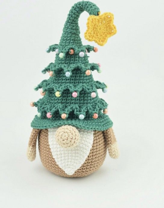 a crocheted stuffed animal with a christmas tree on it's head is shown