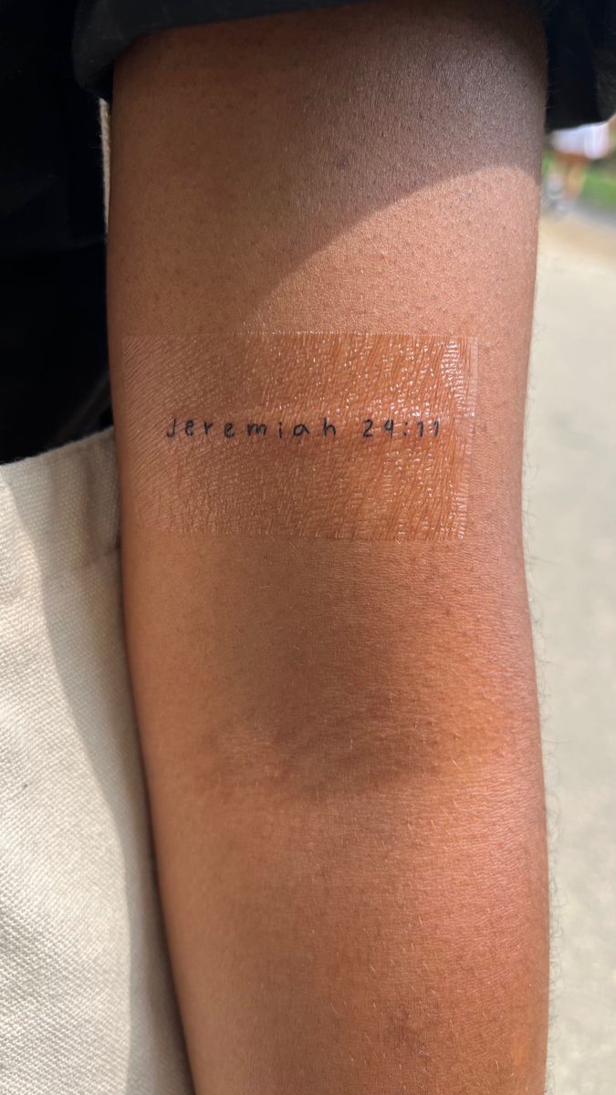 a person with a tattoo on their arm that reads, jeremah 2012 in cursive writing