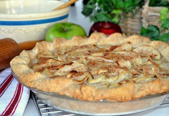 an apple pie sitting on top of a metal rack