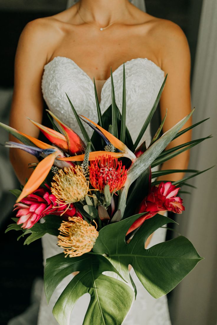 a bride holding a bouquet of flowers in her hands