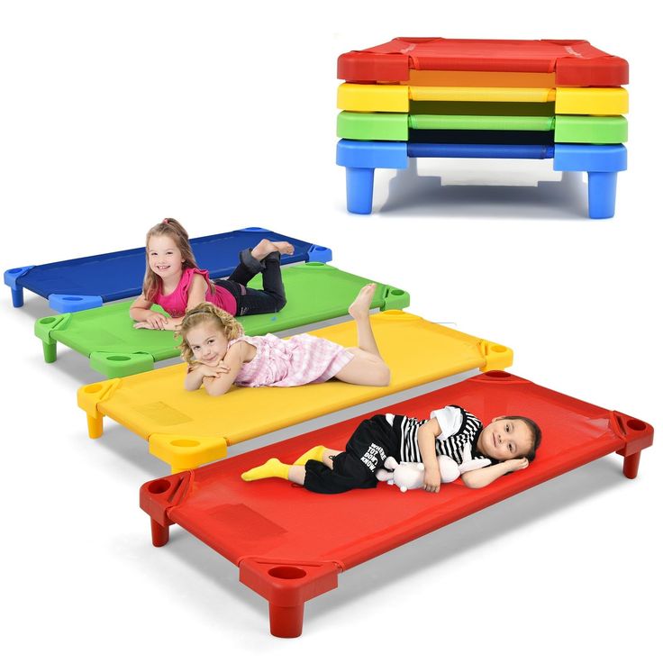 three children laying on different colored toddlers'cots with their legs spread out