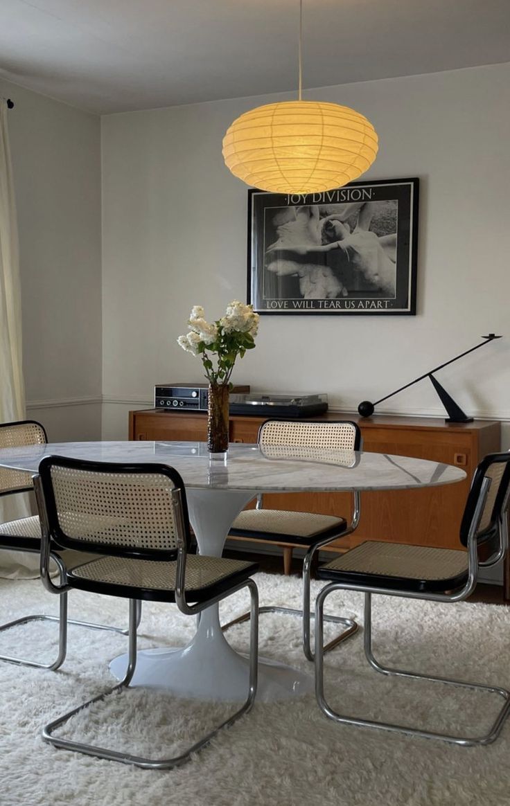 a dining room table with four chairs around it