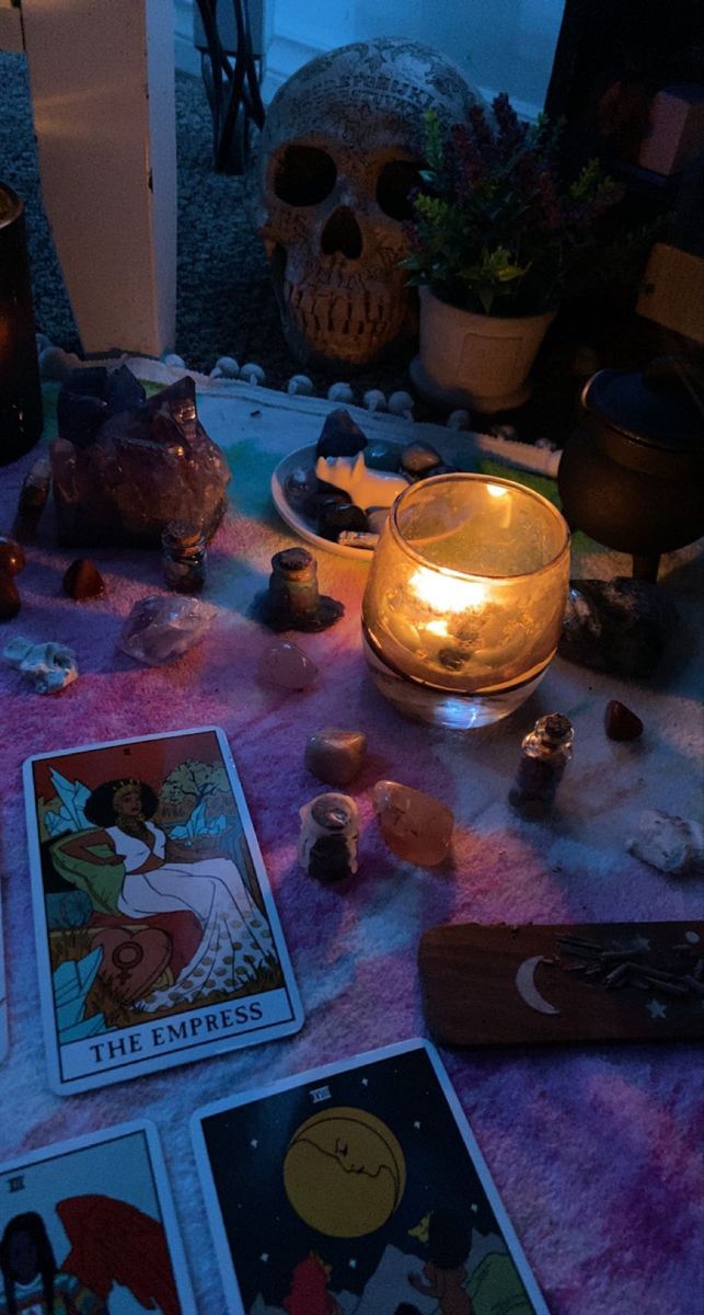 the tarot cards are on the table next to candles and other items that have been placed around them