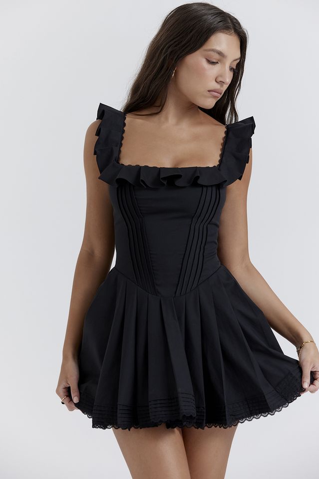 Details
The fun and feminine vibe of 'Jemima' makes it a pretty favourite for seasons to come. Cut from stretch black cotton with delicate pin tuck detailing. 'Jemima' is designed with a corset inspired bodice for a close fit and we love the pretty ruffle straps and neckline.

It falls to a softly pleated mini skirt and the scalloped trims enhance the feminine feel. It's fully lined for comfort and zips up the back for easy on. 
Size Chart
            US UK EU AU   XS 2 6 34 6   S 4 8 36 8   M 6 10 38 10   L 8-10 12 40 12 Little Black Dresses, Black Pins, Mini Sundress, Pleated Mini Skirt, Dress Cuts, Black Ruffle, Corsets, Drop Waist, 8 M