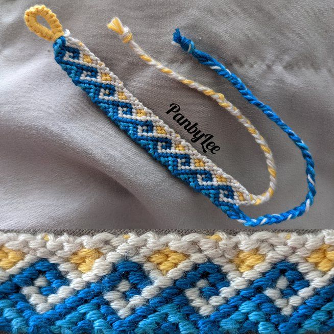 a blue and yellow bracelet sitting on top of a white cloth next to a piece of fabric