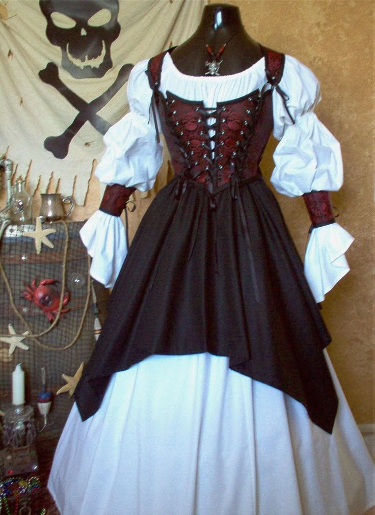 This listing consists of: Bodice Cuffs Lacing Underskirt Overskirt *If you would like another color underskirt other than white, please let us know. Shirt and all other accessories are not included. Skirt is shown over a hoopskirt, which is not included. Bodice: It is made from beautiful blood red and black skull brocade fabric Lined in a thick black cotton duck and interlined with an additional layer of thickness for added durability. It is trimmed in black and we have used black professional g Steampunk Pirate Costume, Pirate Aesthetic, Female Pirate Costume, Fair Outfit, Harry Clarke, Mode Steampunk, Steampunk Pirate, Pirate Outfit, Fair Outfits