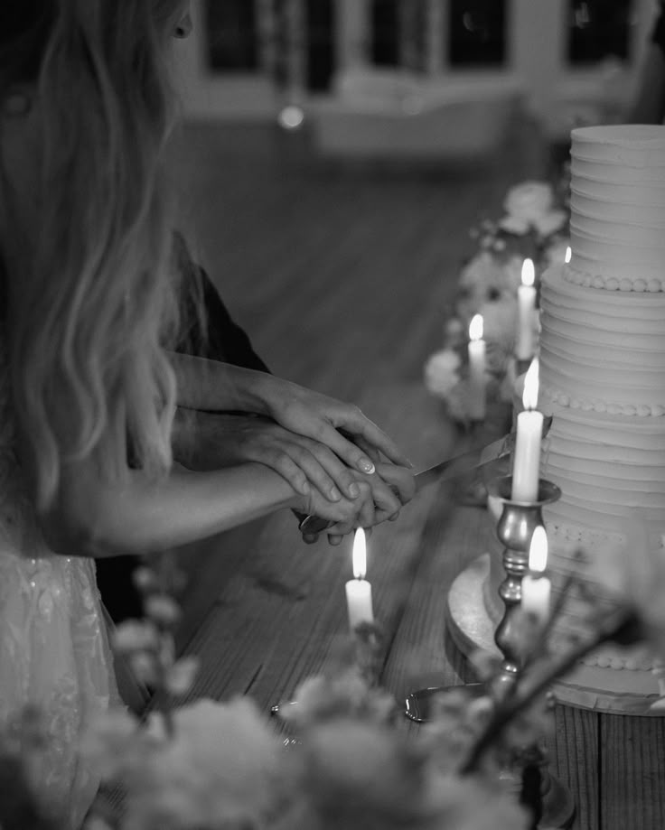 the bride and groom are getting ready to cut their wedding cake at the reception table