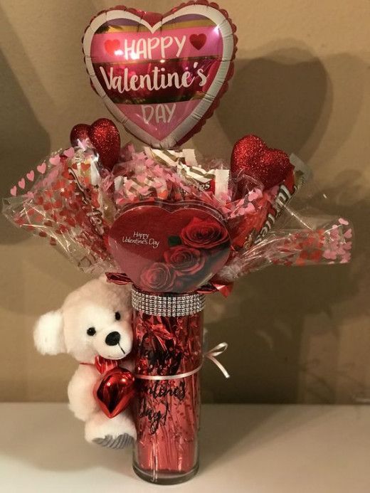 a valentine's day bouquet in a vase with a teddy bear