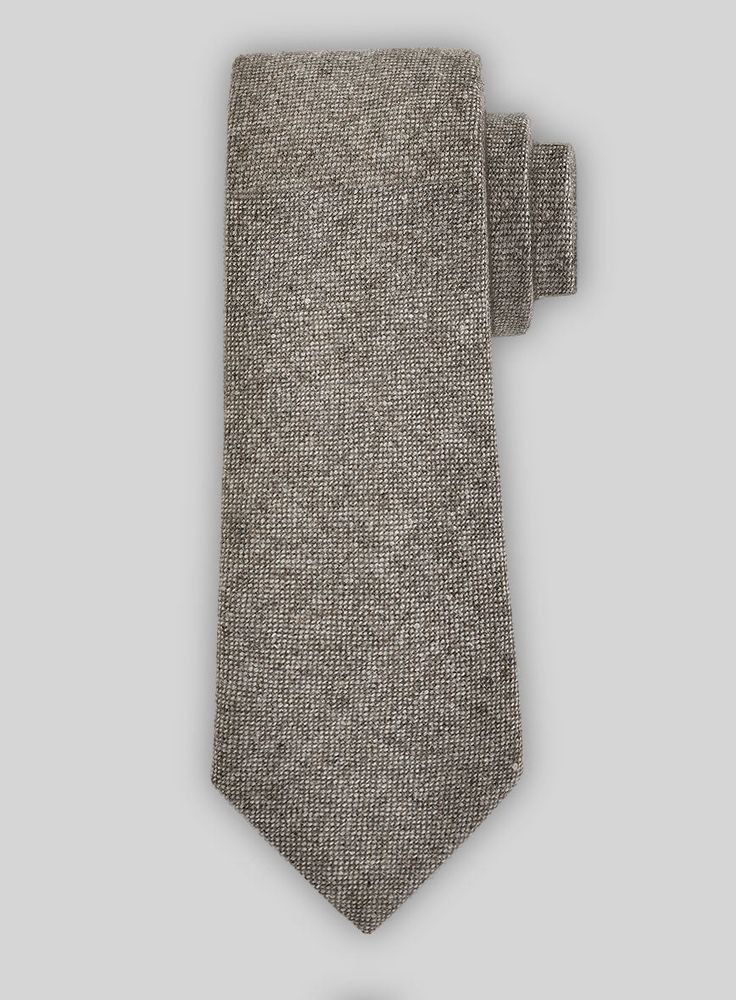 This Tweed Tie is hand crafted with premium finish.  Perfect for suits and blazers, it adds a unique touch with its solid design.  Must-have for any neckwear collection.  Width: 2.75 inches. Elegant Formal Tweed Jacket With Herringbone Pattern, Elegant Fitted Winter Tie, Elegant Suit And Tie Accessories For Fall, Elegant Fall Ties, Classic Formal Ties For Winter, Classic Winter Formal Ties, Elegant Fitted Ties For Fall, Elegant Fall Standard Tie, Classic Wool Suit And Tie Accessories For Fall