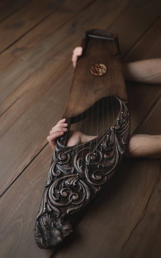 a person laying on the floor with a harp