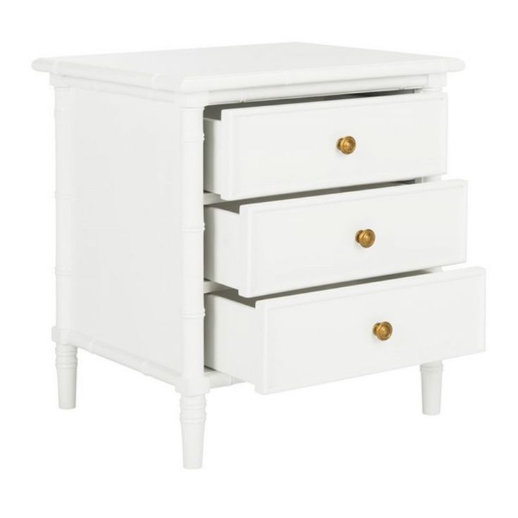 a white nightstand with three drawers and gold knobs on the bottom, against a white background