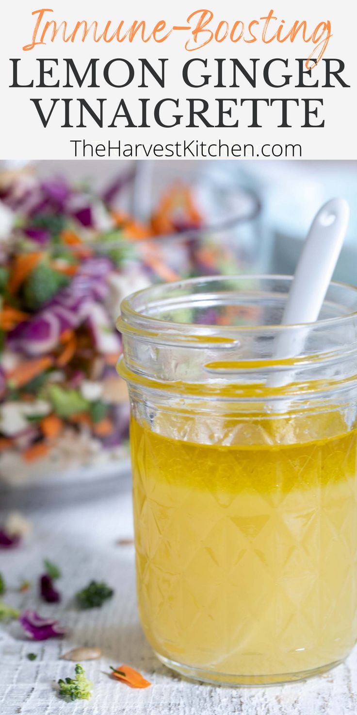 a mason jar filled with lemon ginger vinaigrette on top of a table