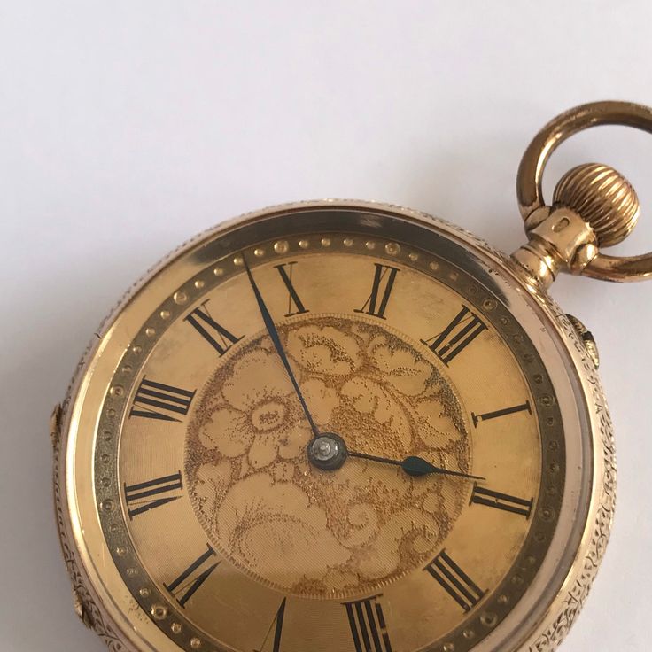 ANTIQUE Ladies 14k Gold Fob/Pocket Watch. c.1900. This is a beautiful time piece.  Beautiful floral engraved 14k gold case, having vacant shield cartouche to rear of case. Inner back hallmarked 14k gold. Guilded dial with floral engraving to centre. Black roman numeral chapter ring. Blue steel hands.  Mechinal Swiss movement. Bow wound. Watch dimensions - 31mm diameter. Height inc bow 47mm. This watch is sold with a 12 month guarantee from MBHI certificated watchmakers, established 1947. All watches will be serviced before shipping hence the 2-3 week dispatch. Please note - Watches are not waterproof unless otherwise stated and it is recommended not to wear them near water (i.e. washing hands, washing up, shower, swimming etc). Vintage Round Pocket Watch For Wedding, Wedding Vintage Pocket Watch, Antique Collectible Chronometer Pocket Watch, Vintage Medallion Pocket Watch For Wedding, Vintage Medallion Pocket Watch For Weddings, Antique Yellow Gold Pocket Watch Collectible, Victorian Yellow Gold Pocket Watch With Chronometer, Victorian Pocket Watch With Round Dial For Formal Occasions, Victorian Pocket Watch For Formal Occasions