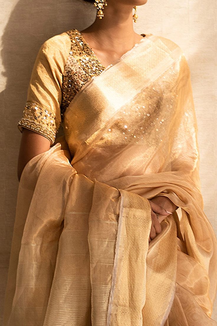 Gold saree with gold borders and pallu. Comes with unstitched blouse fabric.
Component: 2
Pattern: Woven
Type Of Work: Thread
Fabric: Silk Tissue Maheshwari
Color: Gold
Other Details: 
Frayed hems
Note: The blouse worn by the model is not for sale
Occasion: Wedding - Aza Fashions Maheshwari Saree, Gold Saree, Saree Women, Sarees Silk, Saree For Women, Gold Silk, Gold Thread, Buy Gold, Fabric Silk