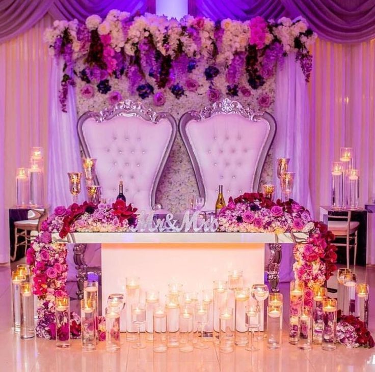 a decorated table with candles and flowers on it