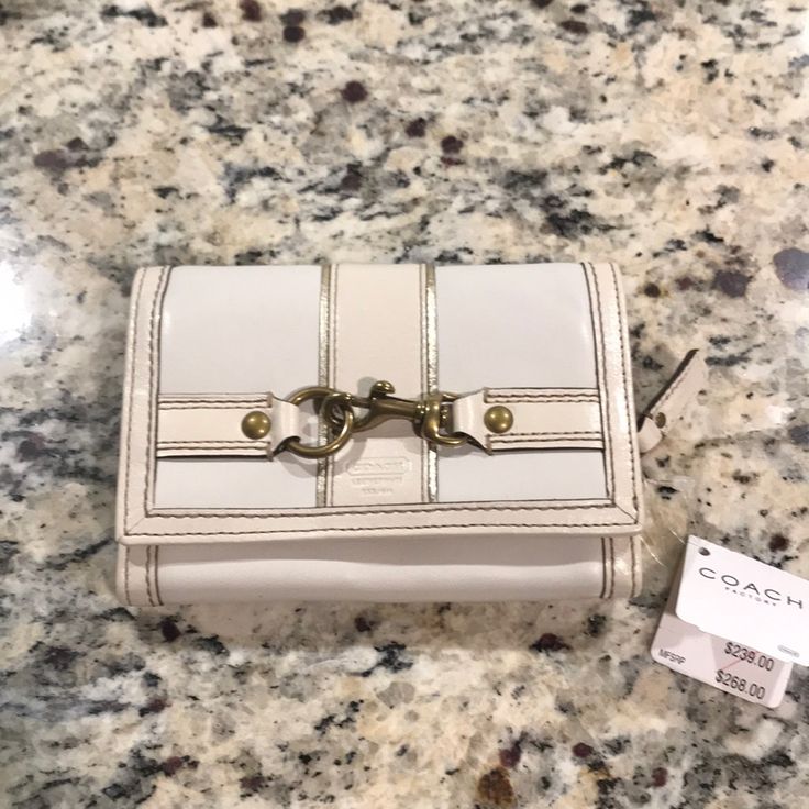 Brand New With Tags Ivory And Gold Buckle Coach Wallet Beautiful Detail And Design Luxury Cream Wallet For Daily Use, Cream Clutch Wallet For Gift, Cream Clutch Wallet As Gift, Cream Clutch Wallet Perfect For Gifts, Luxury White Coach Wallet, Cream Coin Purse For Daily Use, Chic Cream Leather Wallet, Formal White Leather Wallet, Classic Cream Wallets For Daily Use