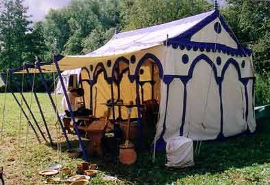 there is a tent in the grass with pots and pans on it