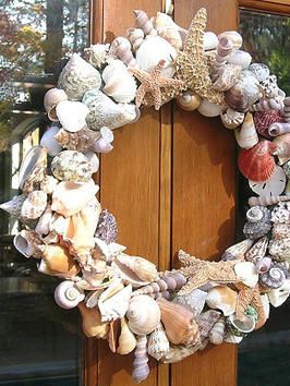 a wreath made out of seashells on a door